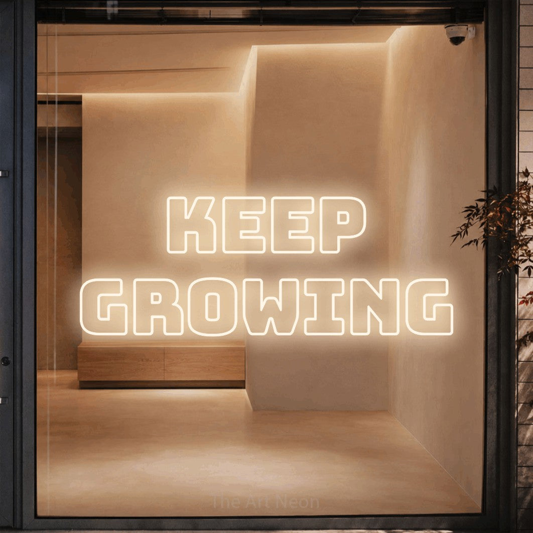 LED neon sign reading “KEEP GROWING”, arranged in 2 lines.