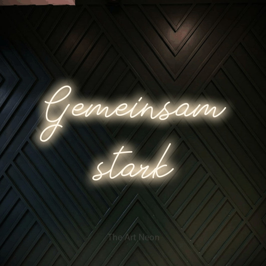 LED neon sign reading “Gemeinsam stark”, arranged in 2 lines.