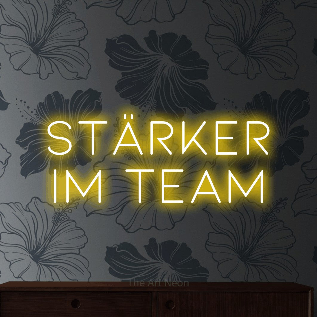 LED neon sign reading “stärker im team”, arranged in 2 lines.