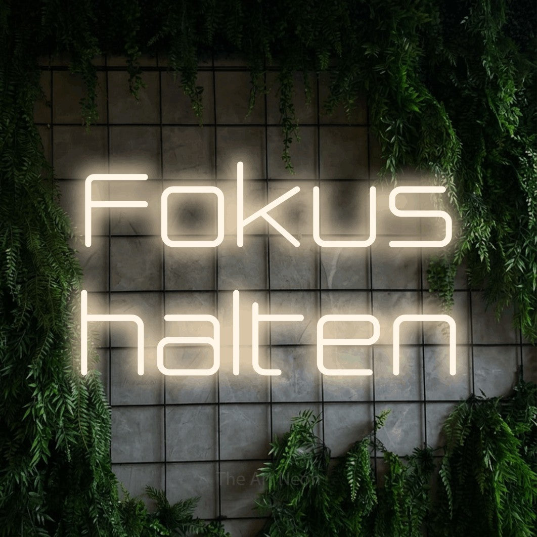 LED neon sign reading “Fokus halten”, arranged in 2 lines.