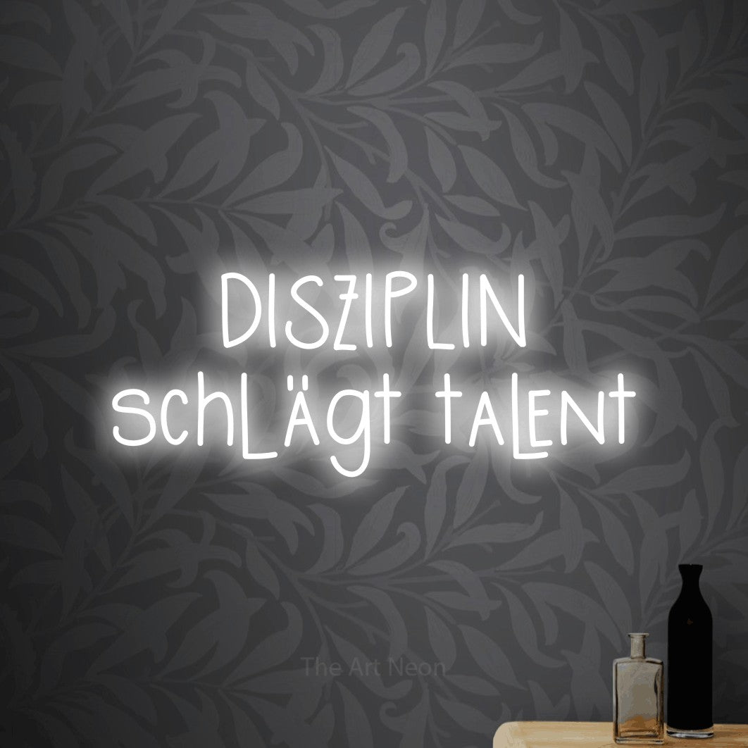 LED neon sign reading “DISZIPLIN schlägt talent”, arranged in 2 lines.