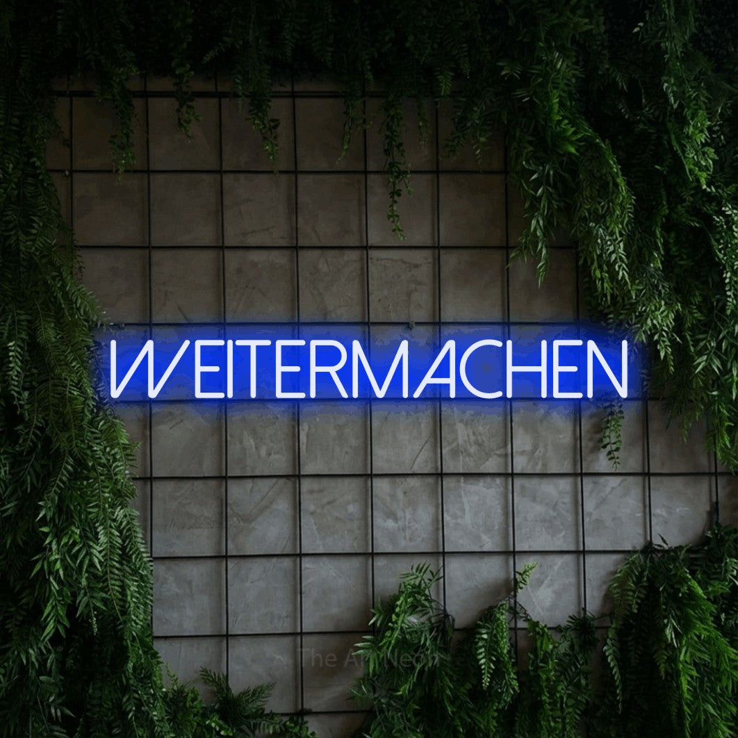 LED neon sign reading “weitermachen”, arranged in a single line.