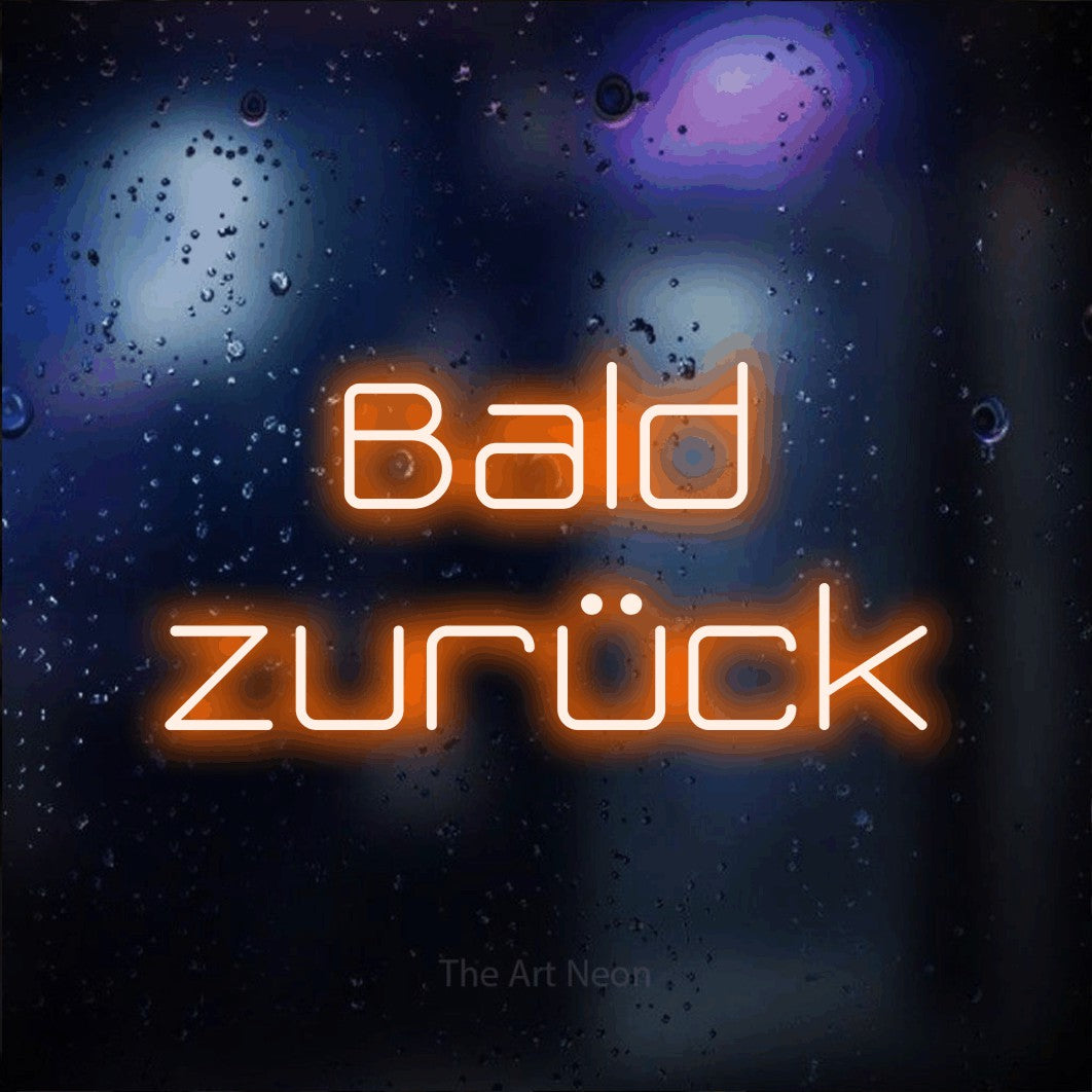LED neon sign reading “Bald zurück”, arranged in 2 lines.