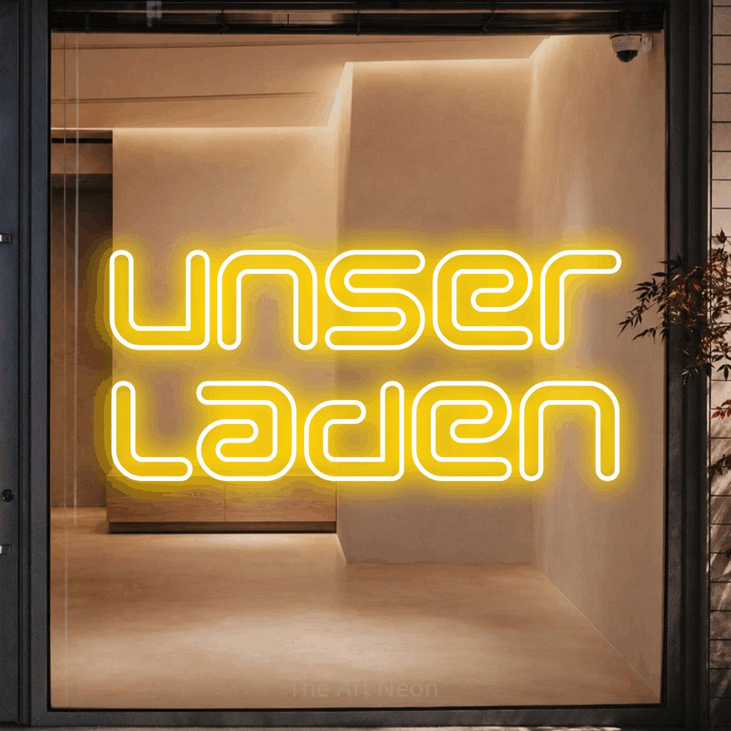LED neon sign reading “unser laden”, arranged in 2 lines.