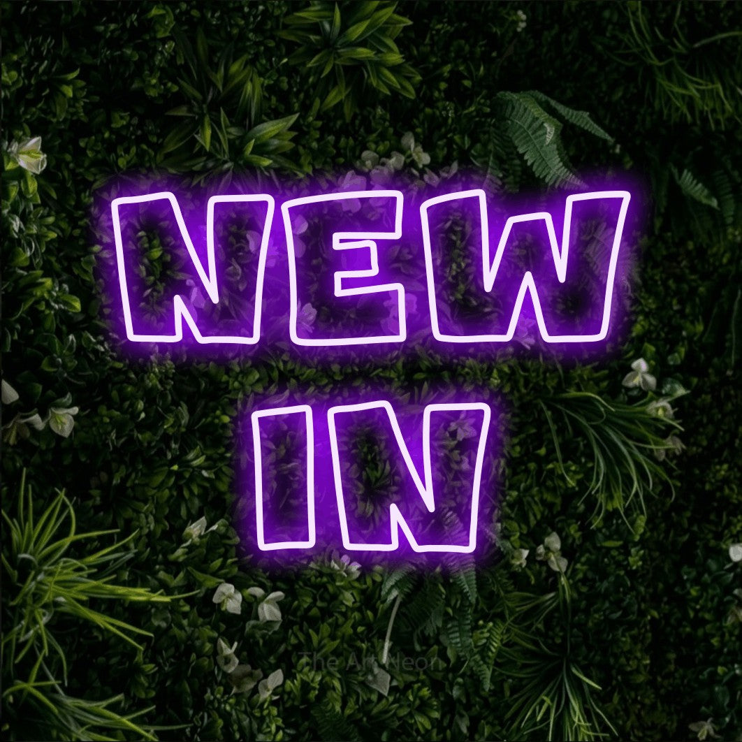 LED neon sign reading “NEW in”, arranged in 2 lines.
