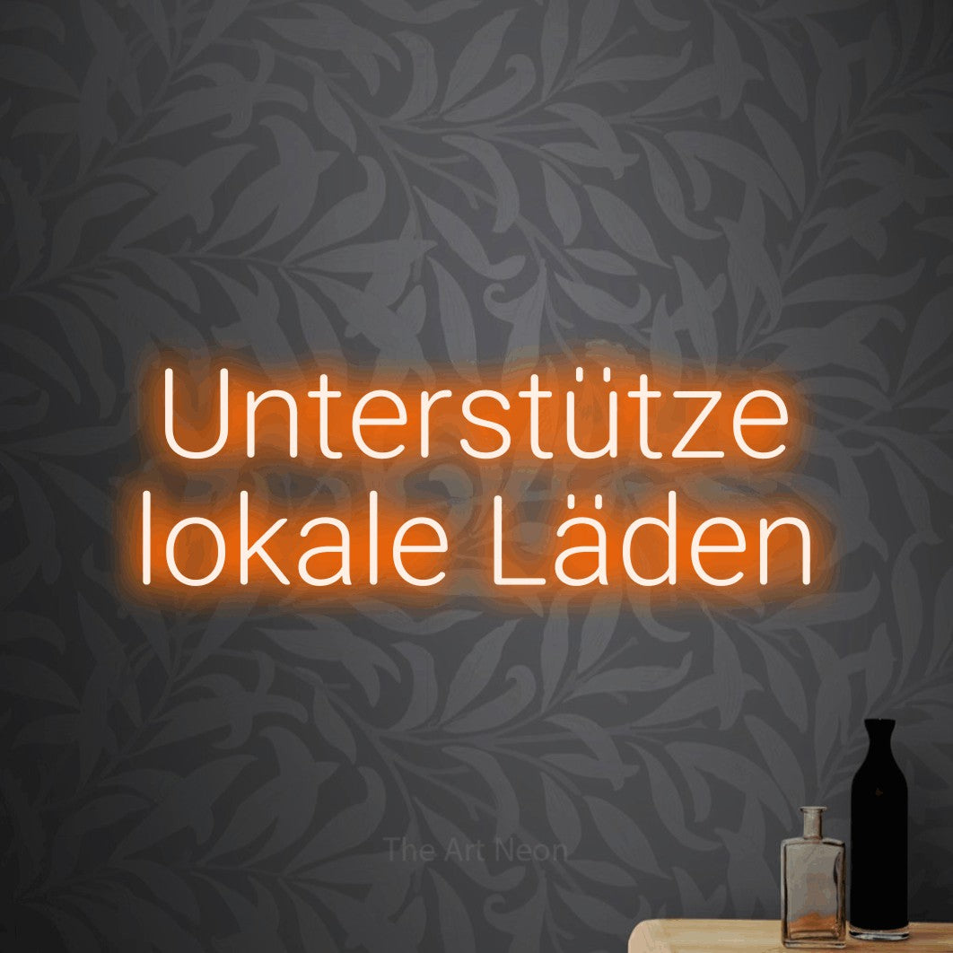 LED neon sign displaying “Unterstütze lokale Läden”.