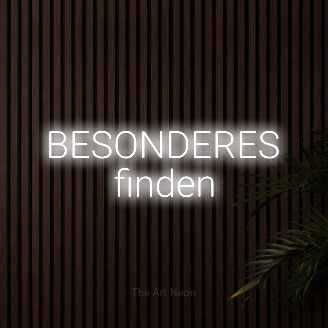 LED neon sign reading “BESONDERES finden”, arranged in 2 lines.