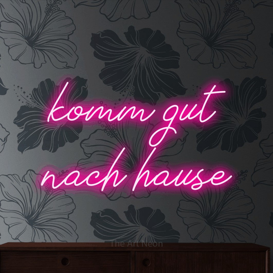 LED neon sign reading “komm gut nach hause”, arranged in 2 lines.