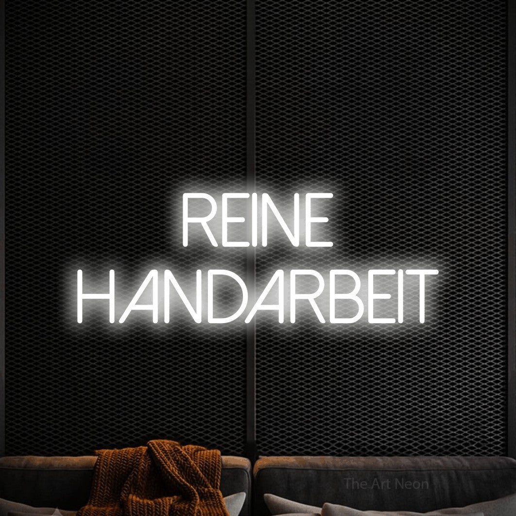 LED neon sign reading “REINE HANDARBEIT”, arranged in 2 lines.