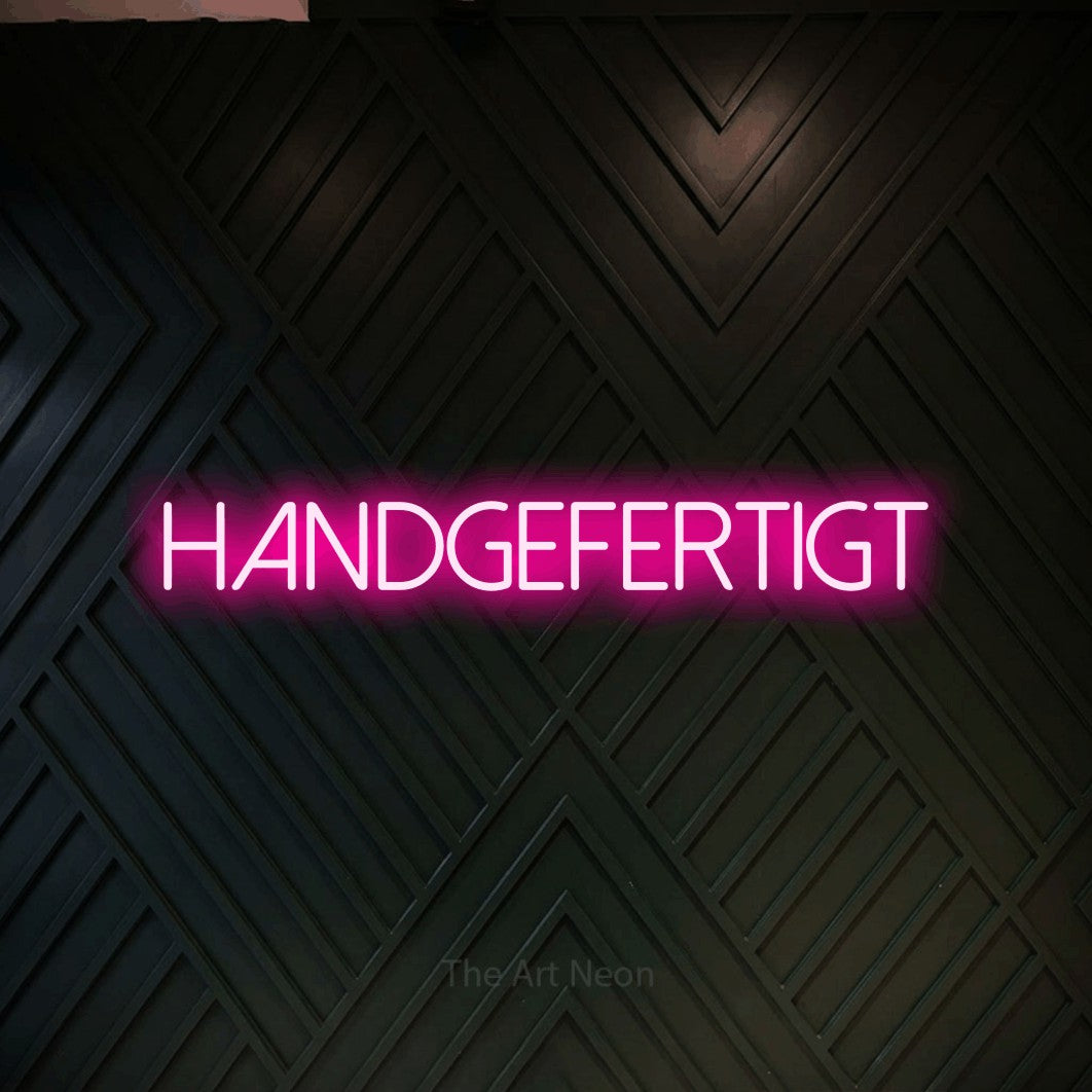 LED neon sign reading “Handgefertigt”, arranged in a single line.