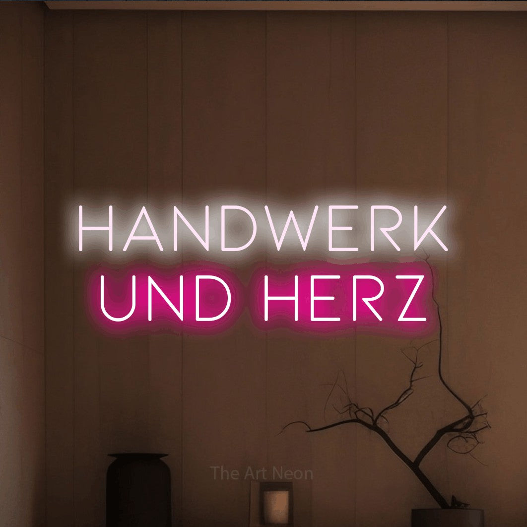 LED neon sign reading “handwerk und herz”, arranged in 2 lines.