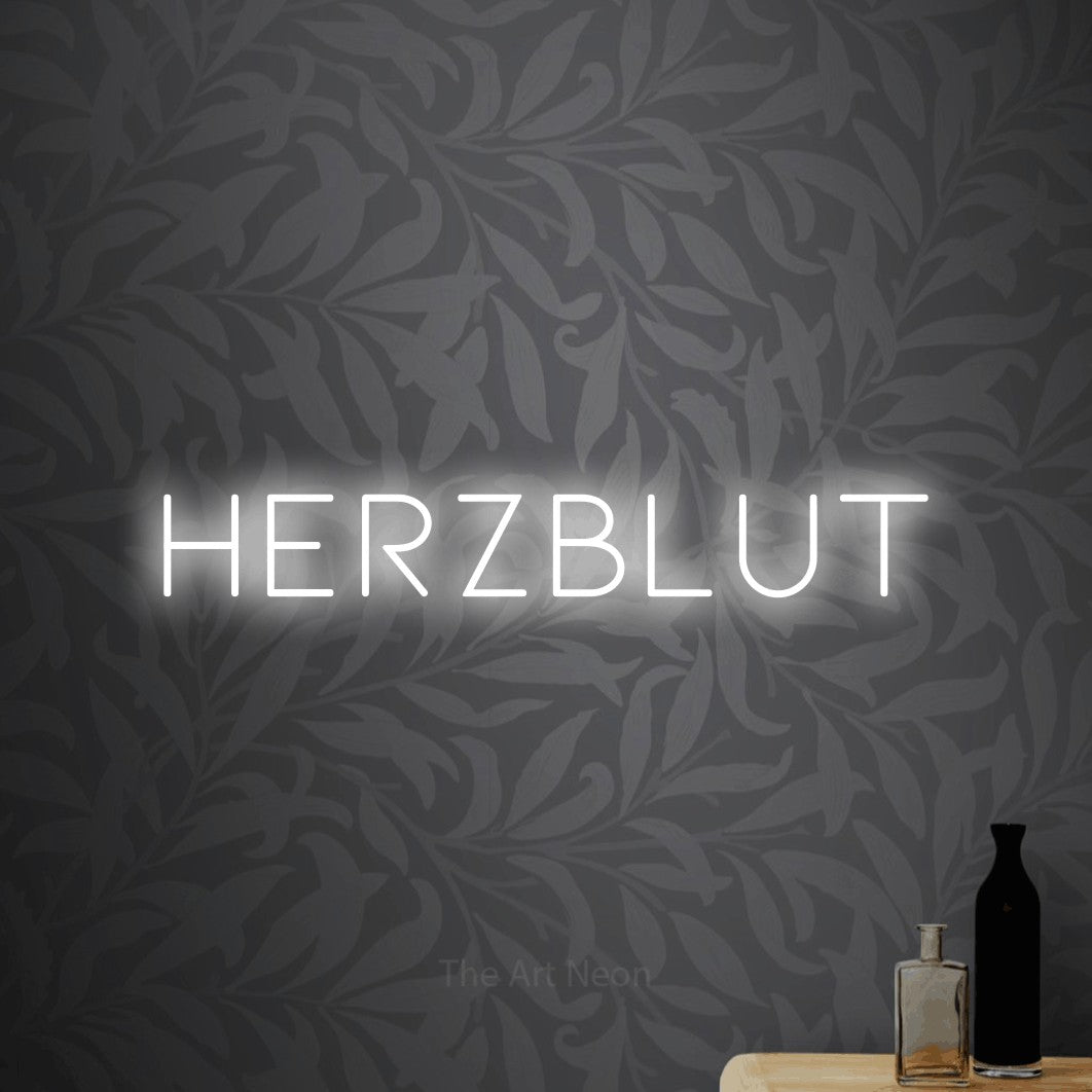 LED neon sign reading “HERZBLUT”, arranged in a single line.