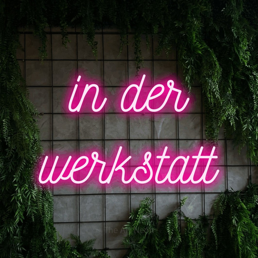 LED neon sign reading “in der werkstatt”, arranged in 2 lines.