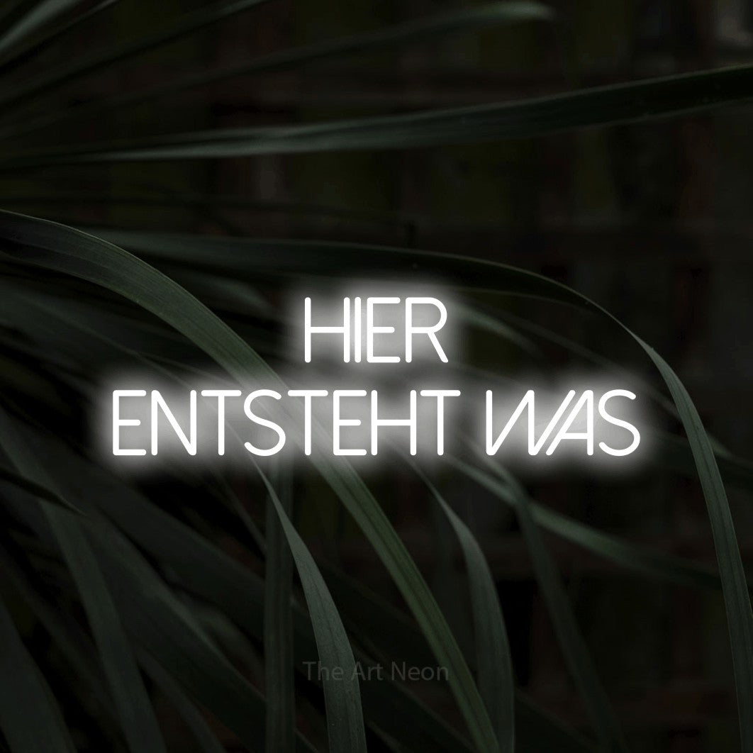 LED neon sign reading “hier entsteht was”, arranged in 2 lines.