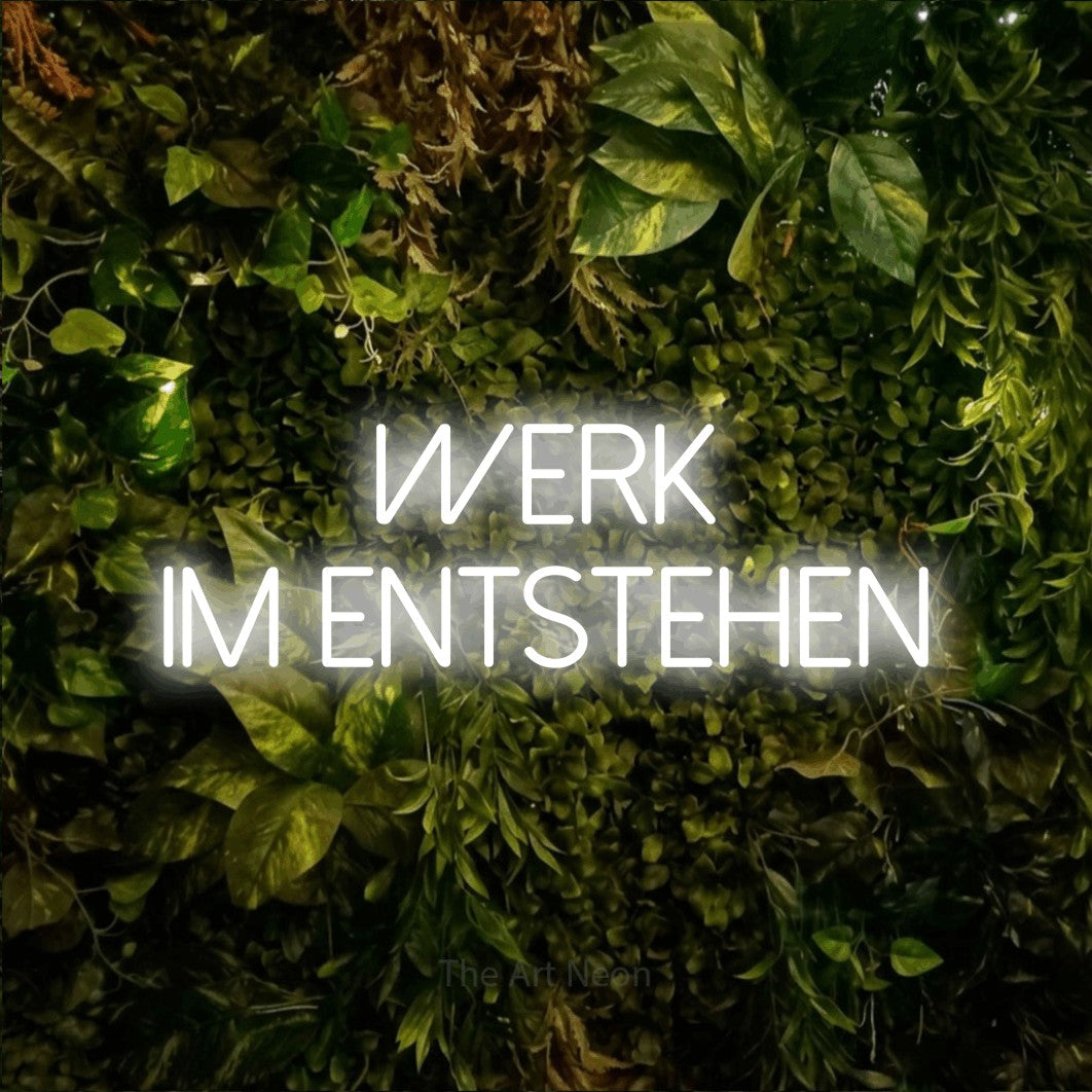 LED neon sign reading “Werk im Entstehen”, arranged in 2 lines.