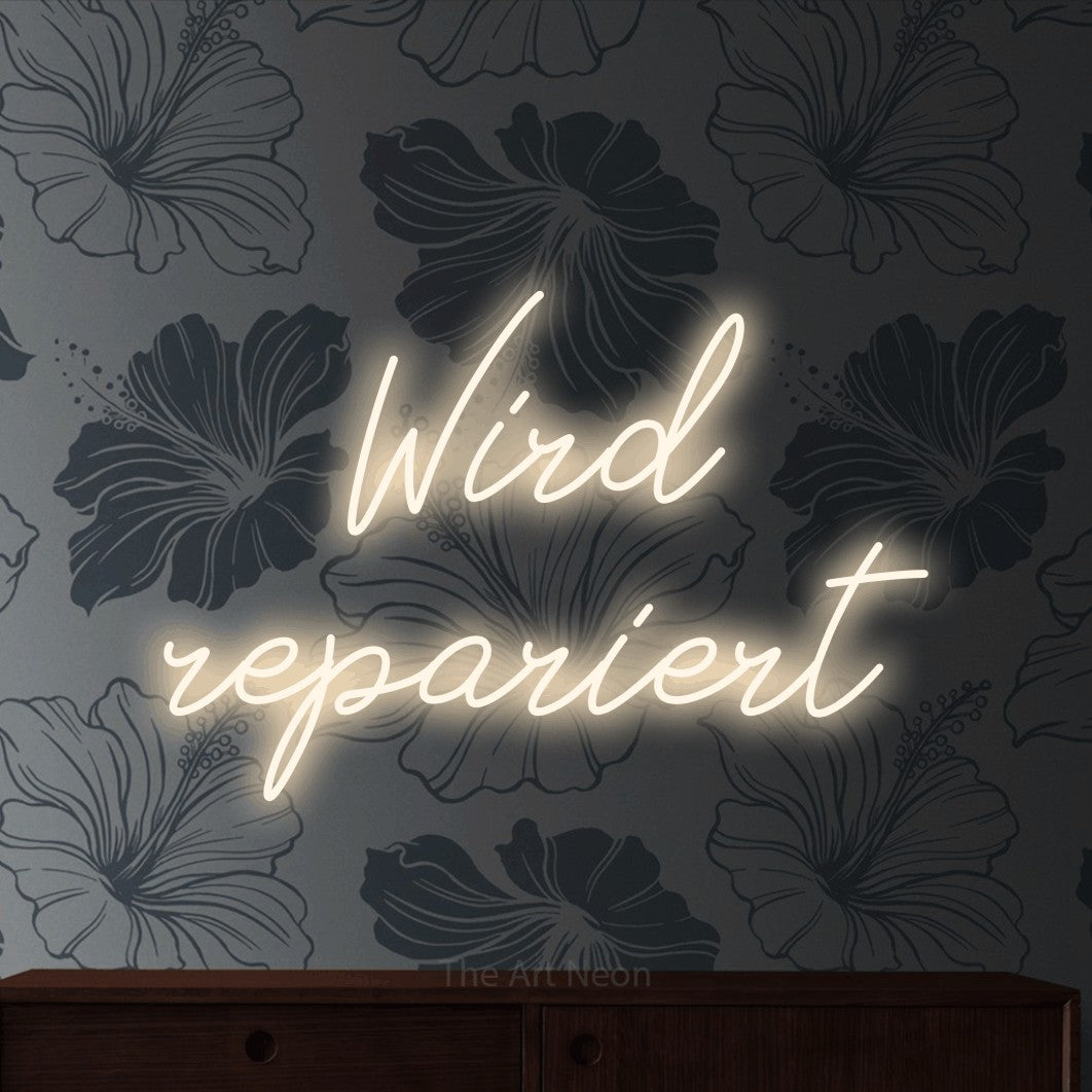 LED neon sign reading “Wird repariert”, arranged in 2 lines.