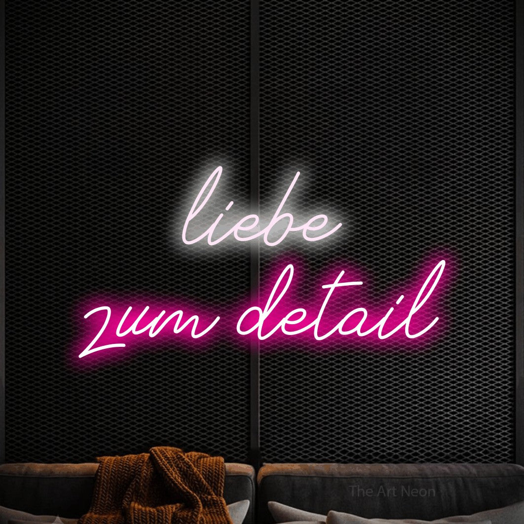 LED neon sign reading “liebe zum detail”, arranged in 2 lines.