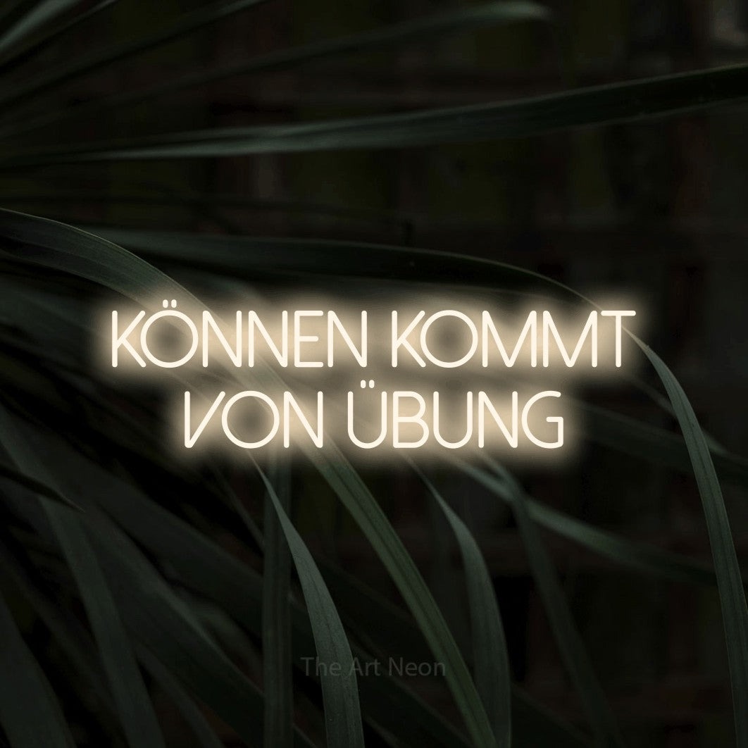 LED neon sign reading “Können kommt von Übung”, arranged in 2 lines.