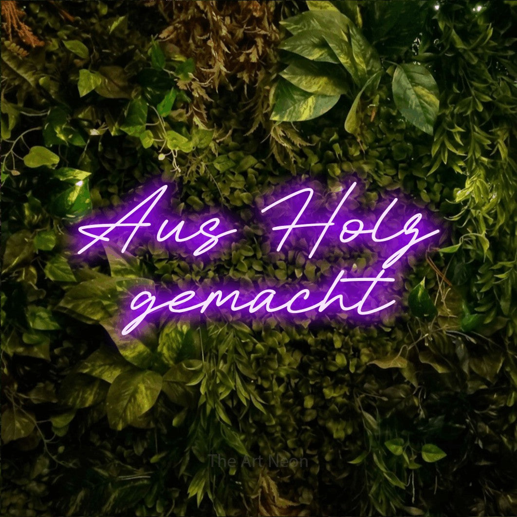 LED neon sign reading “Aus Holz gemacht”, arranged in 2 lines.
