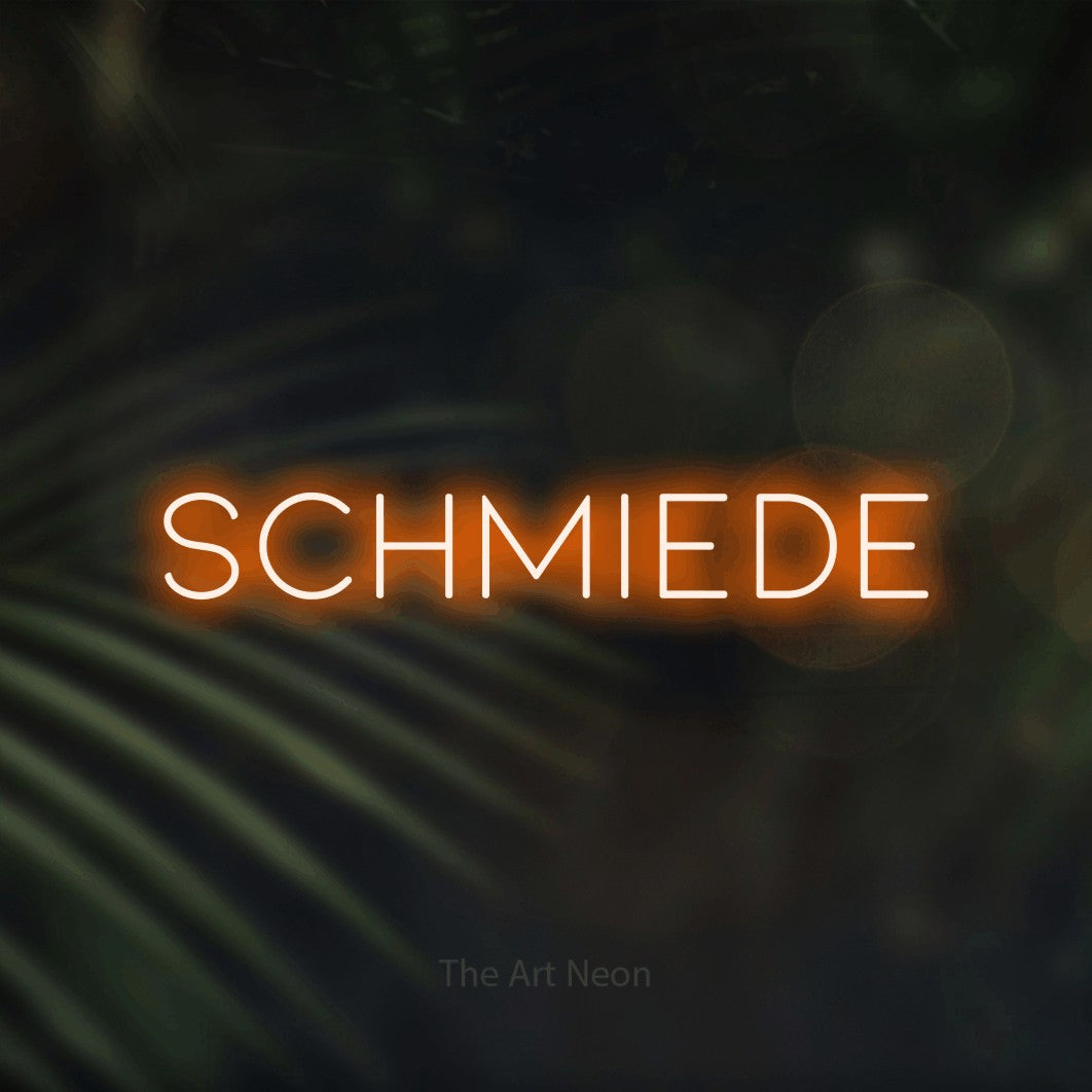 LED neon sign reading “Schmiede”, arranged in a single line.