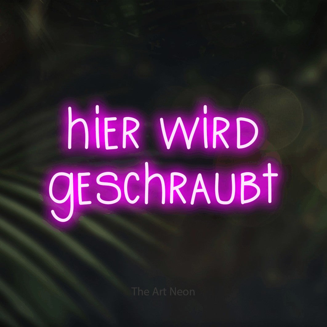 LED neon sign reading “hier wird geschraubt”, arranged in 2 lines.