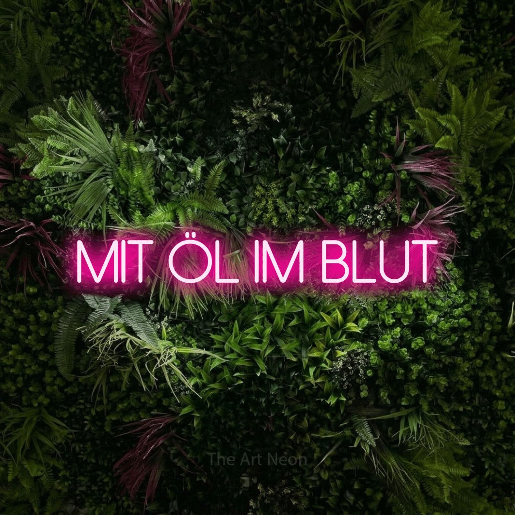 LED neon sign reading “mit öl im blut”, arranged in a single line.