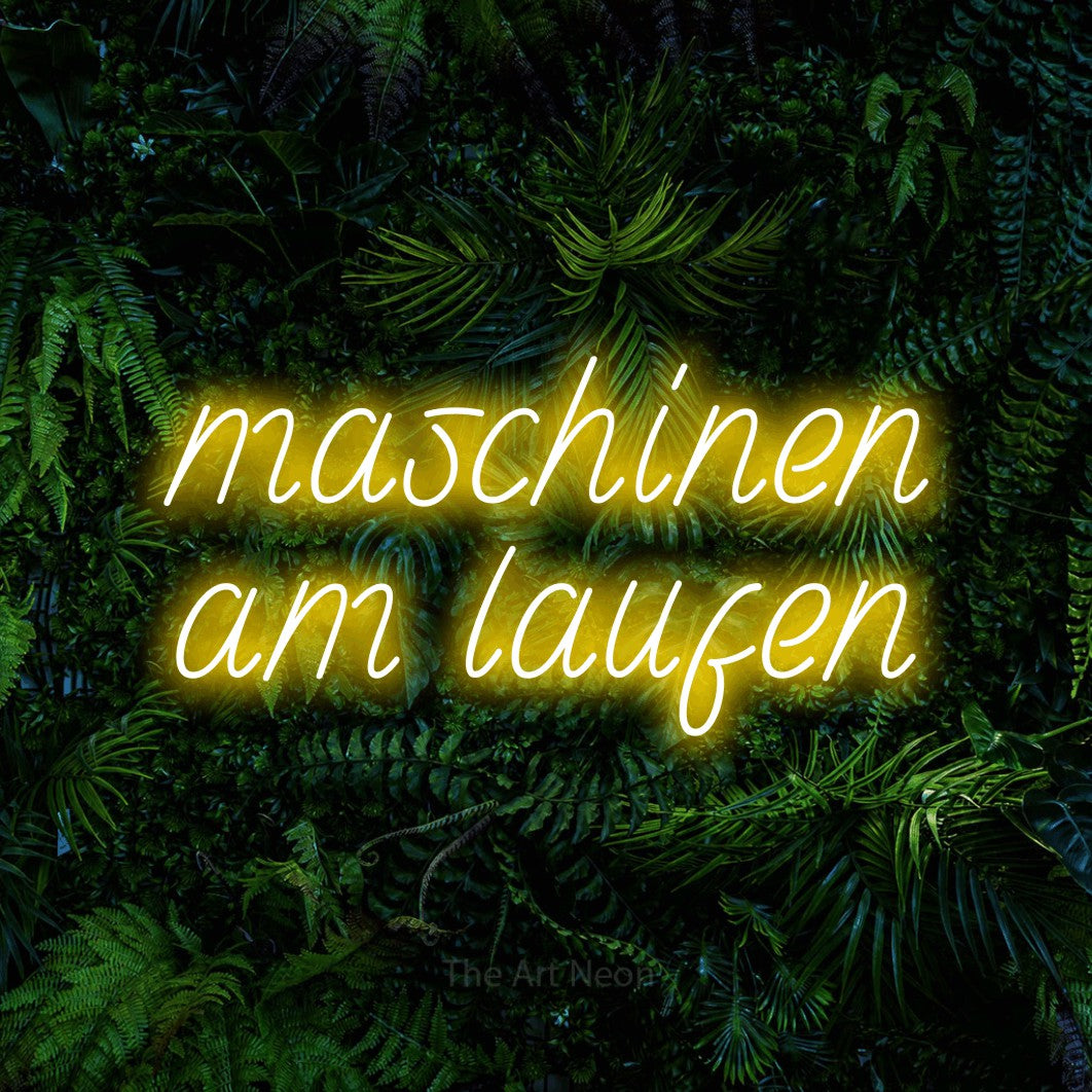 LED neon sign reading “maschinen am laufen”, arranged in 2 lines.