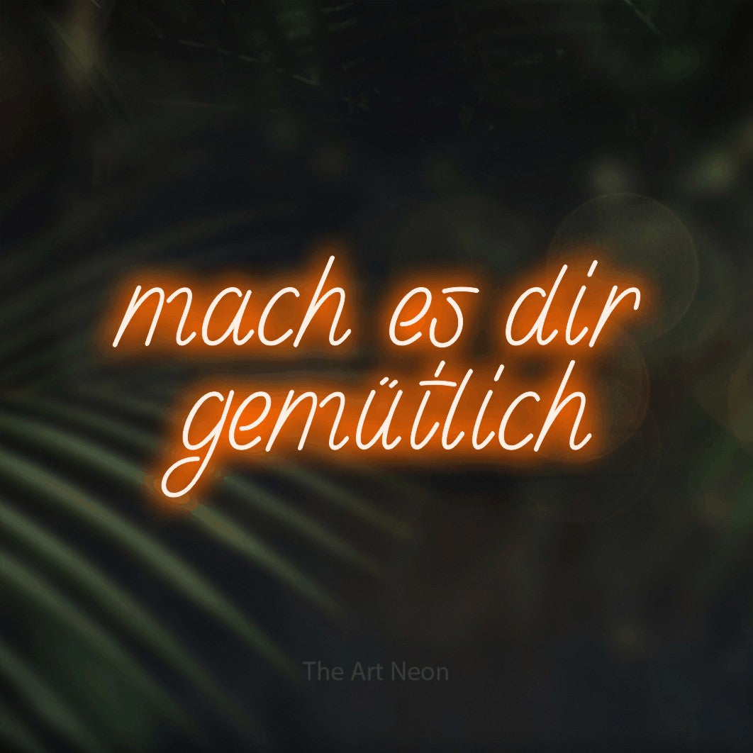 LED neon sign reading “mach es dir gemütlich”, arranged in 2 lines.