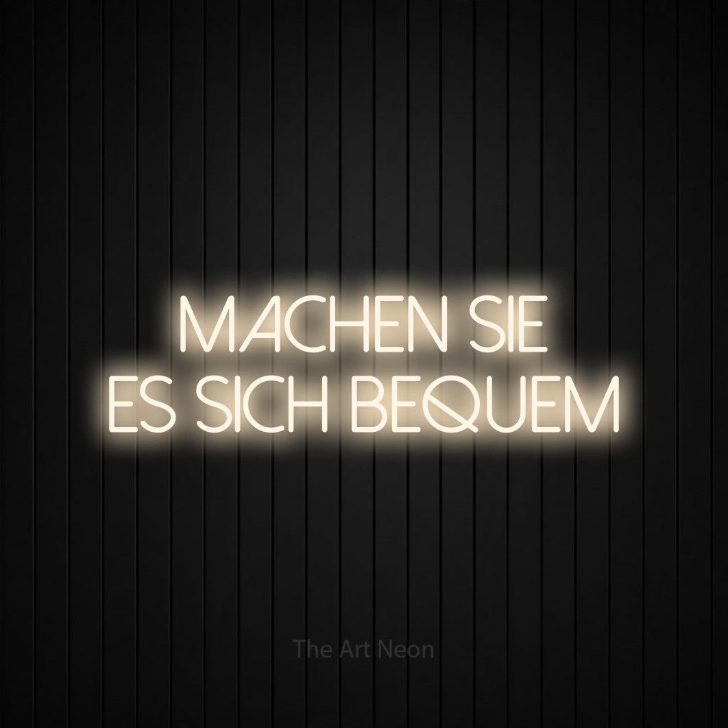 LED neon sign reading “machen sie es sich bequem”, arranged in 2 lines.