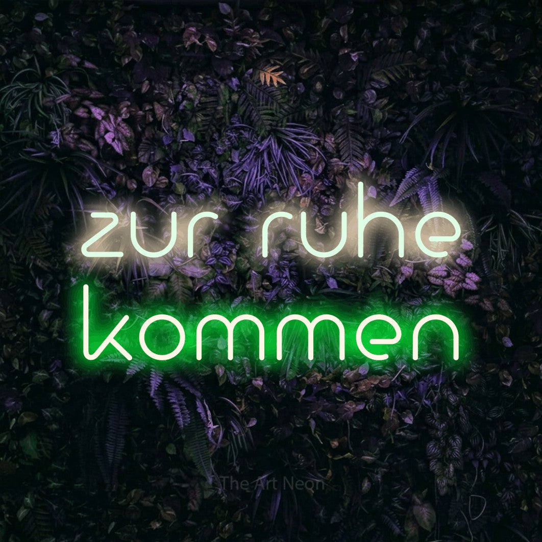 LED neon sign reading “zur ruhe kommen”, arranged in 2 lines.