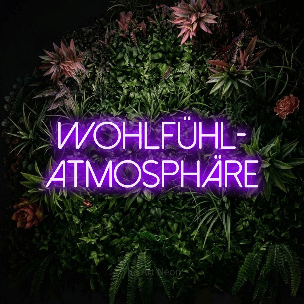 LED neon sign reading “WOHLFÜHL- ATMOSPHÄRE”, arranged in 2 lines.