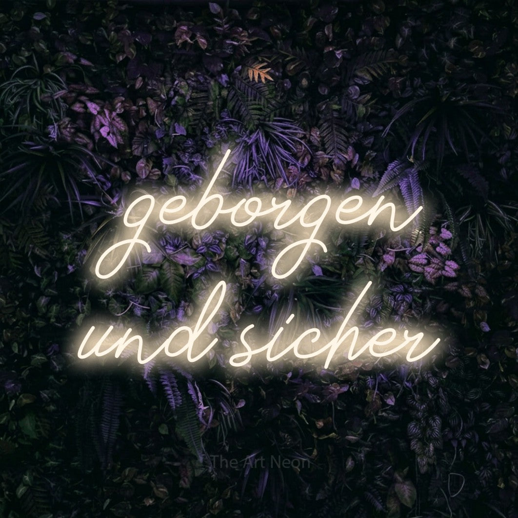 LED neon sign reading “geborgen und sicher”, arranged in 2 lines.