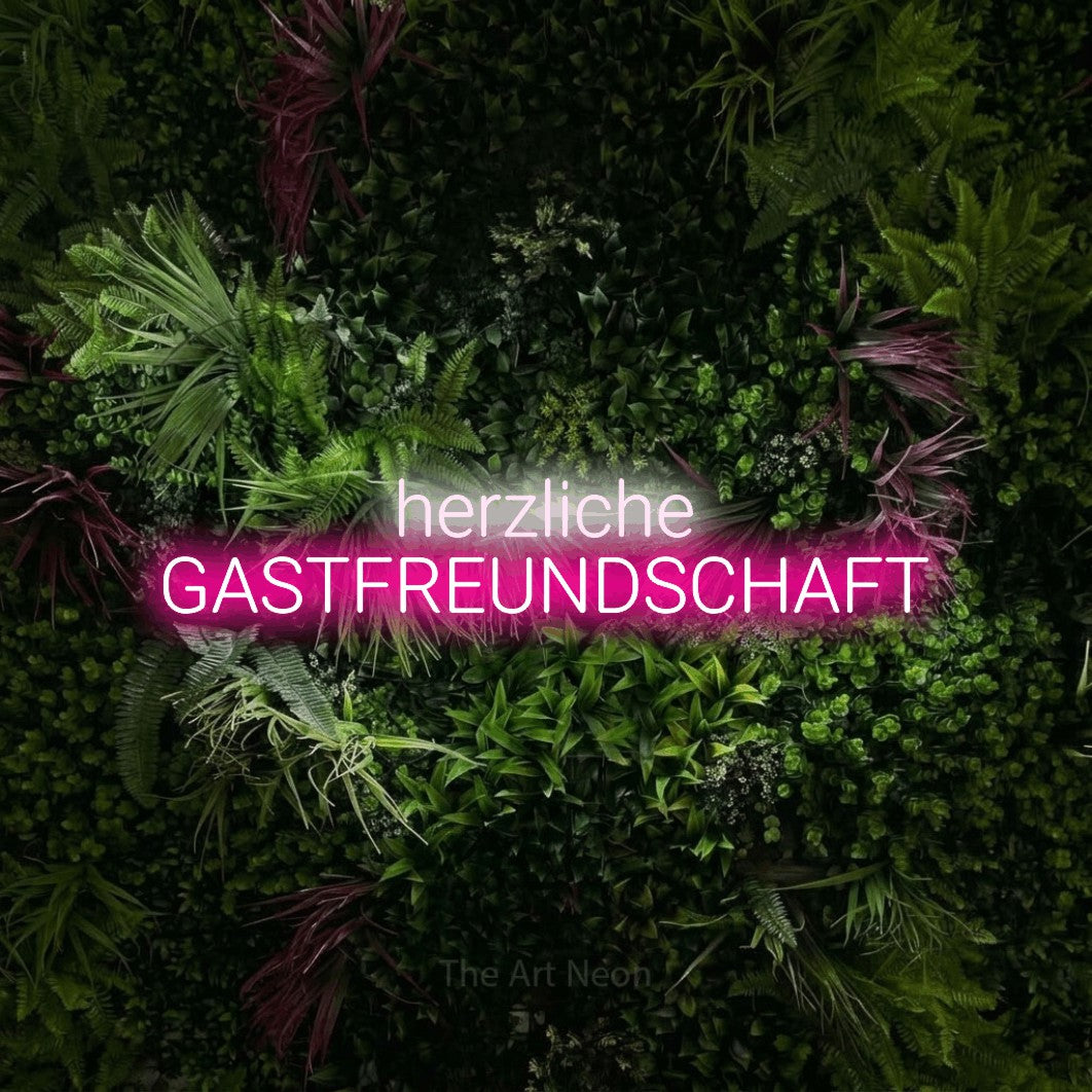 LED neon sign reading “herzliche GASTFREUNDSCHAFT”, arranged in 2 lines.