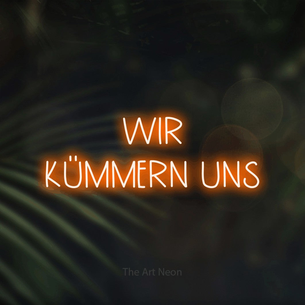 LED neon sign reading “WIR KÜMMERN UNS”, arranged in 2 lines.