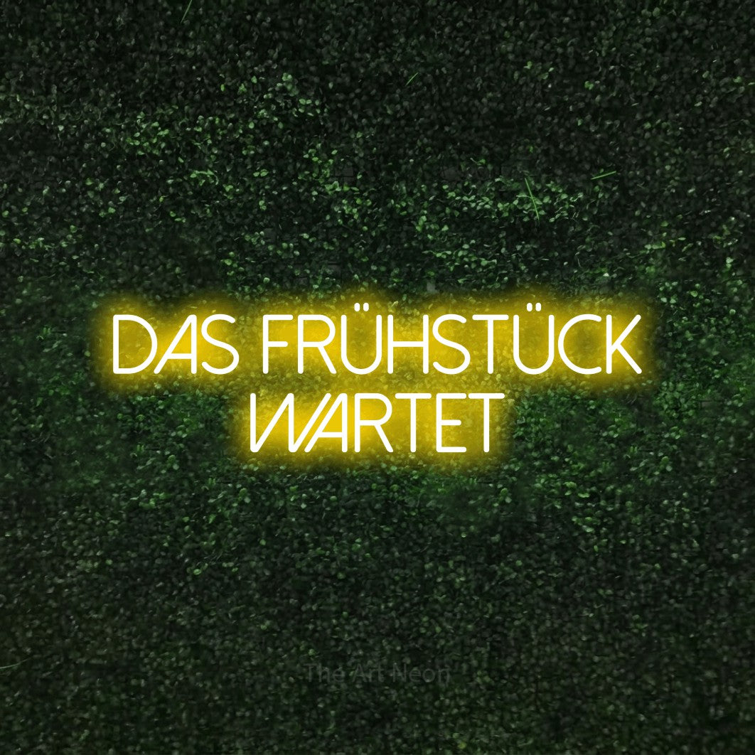 LED neon sign reading “Das Frühstück wartet”, arranged in 2 lines.