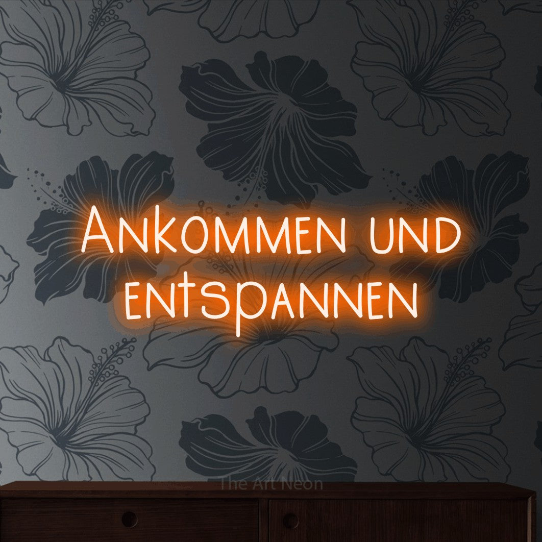 LED neon sign reading “Ankommen und entspannen”, arranged in 2 lines.