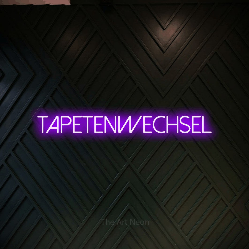 LED neon sign reading “tapetenwechsel”, arranged in a single line.