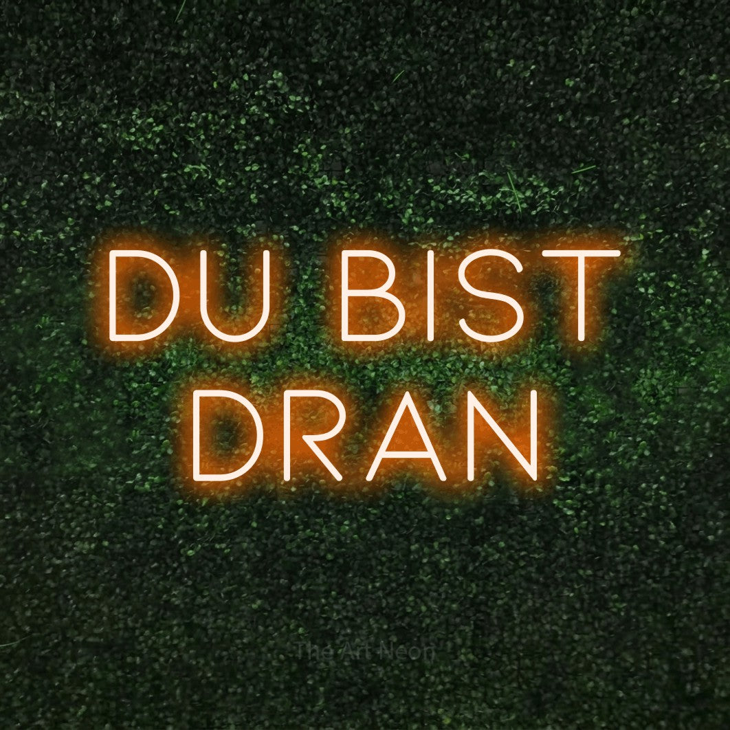 LED neon sign reading “Du bist dran”, arranged in 2 lines.