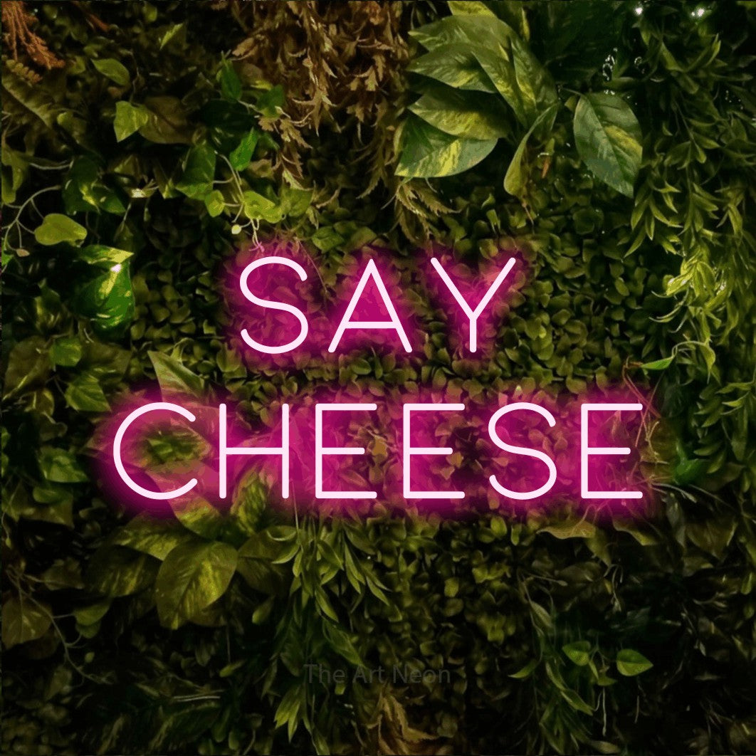 LED neon sign reading “Say Cheese”, arranged in 2 lines.