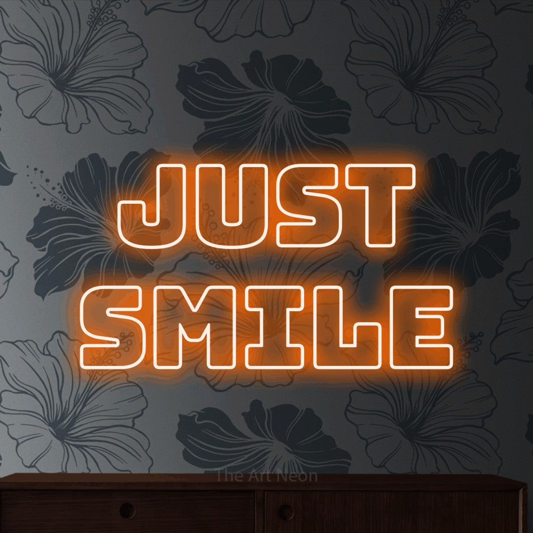 LED neon sign reading “Just Smile”, arranged in 2 lines.