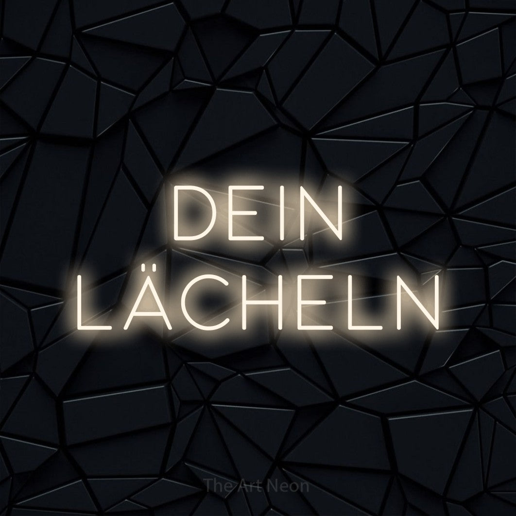 LED neon sign reading “dein lächeln”, arranged in 2 lines.