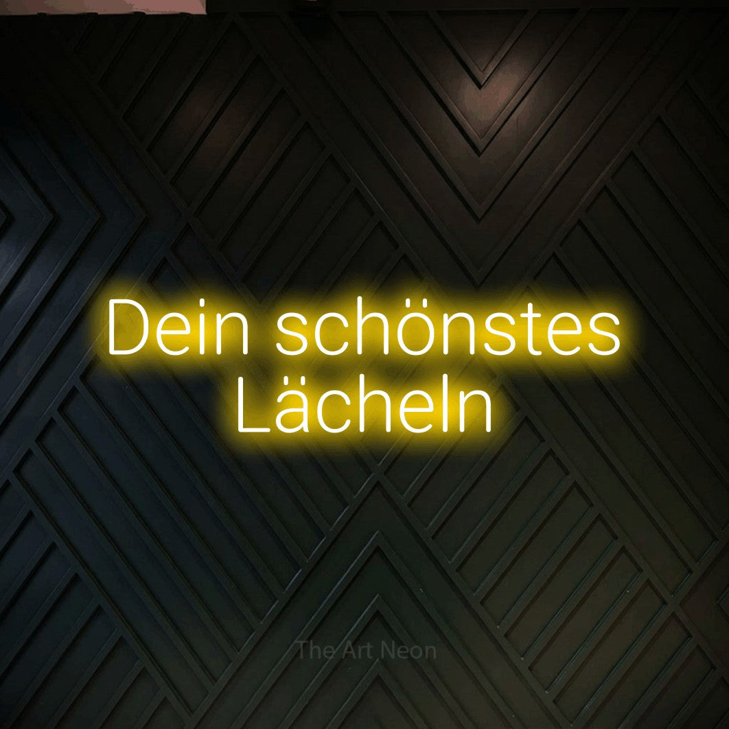 LED neon sign reading “Dein schönstes Lächeln”, arranged in 2 lines.