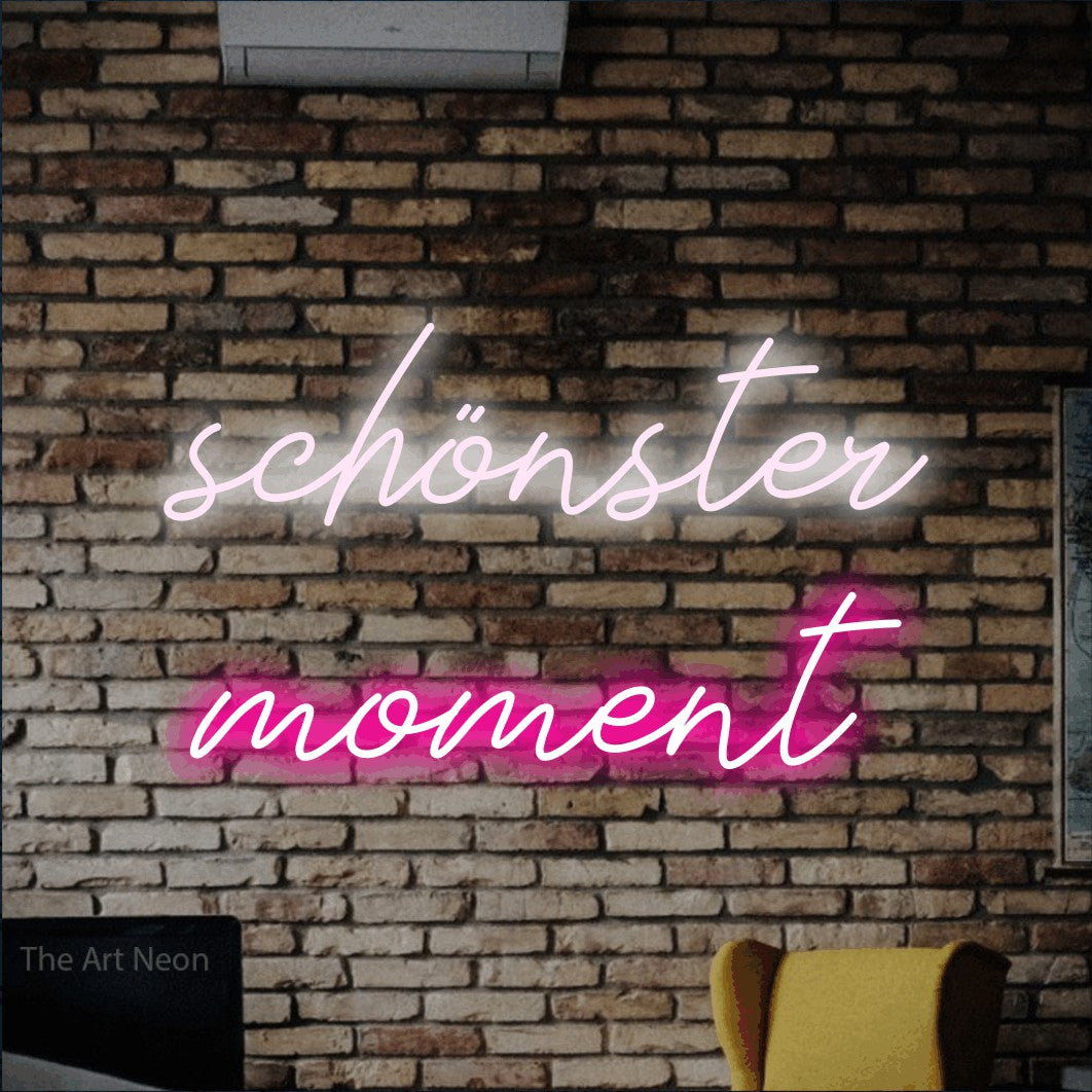 LED neon sign reading “schönster moment”, arranged in 2 lines.