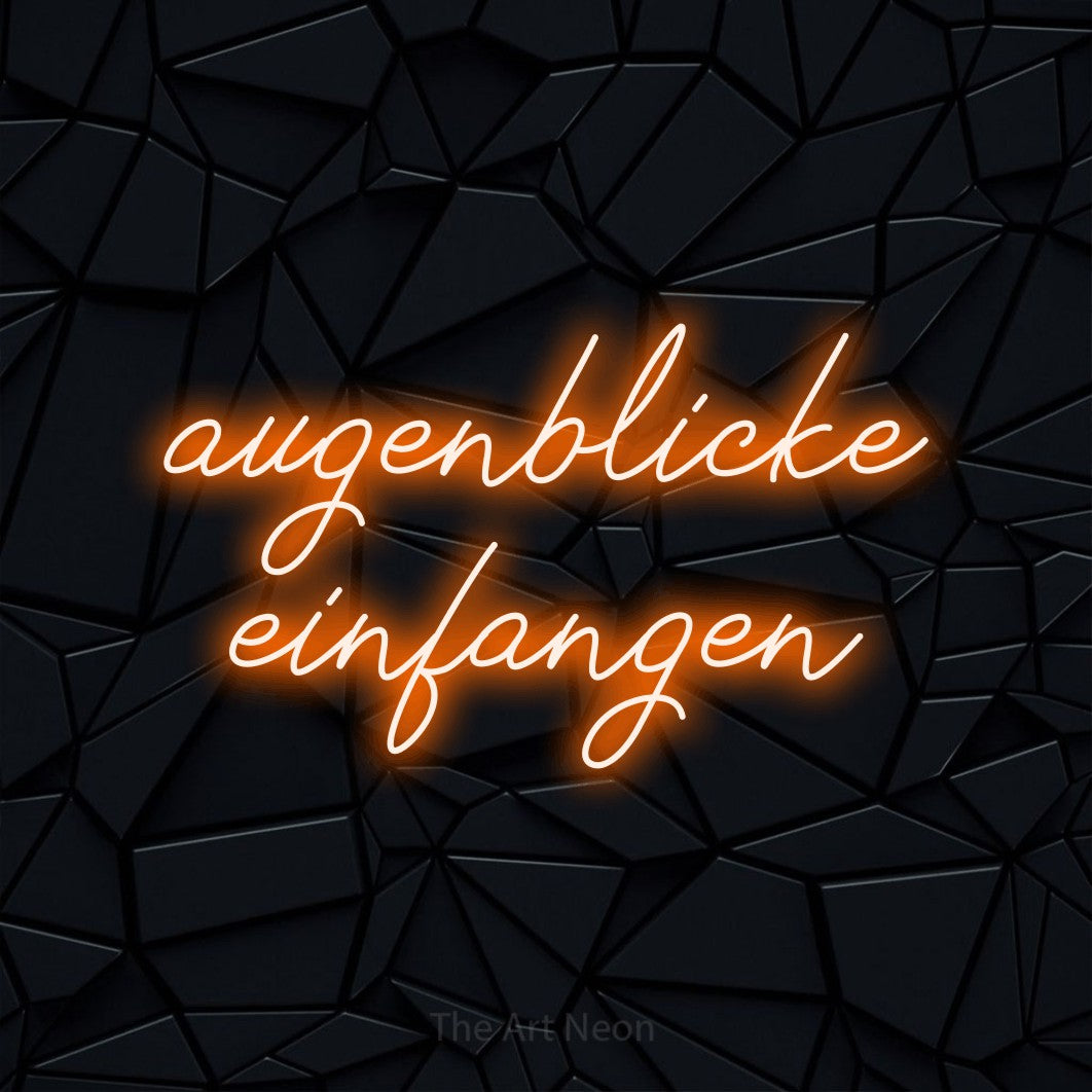LED neon sign reading “augenblicke einfangen”, arranged in 2 lines.