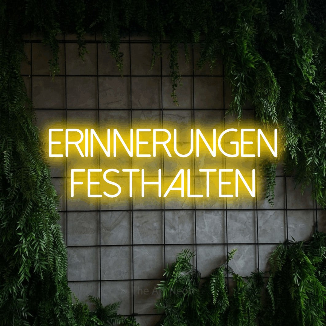 LED neon sign reading “Erinnerungen festhalten”, arranged in 2 lines.