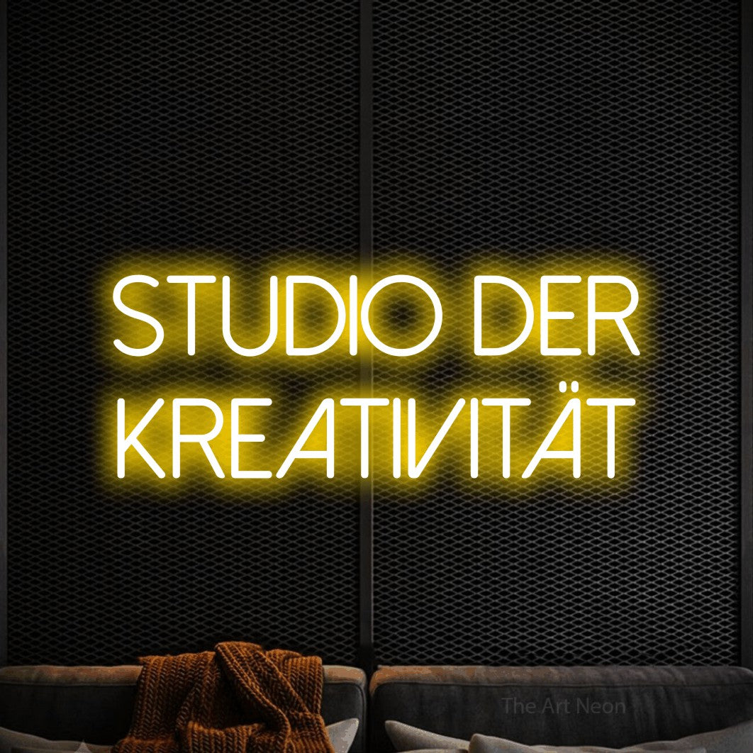 LED neon sign reading “studio der kreativität”, arranged in 2 lines.