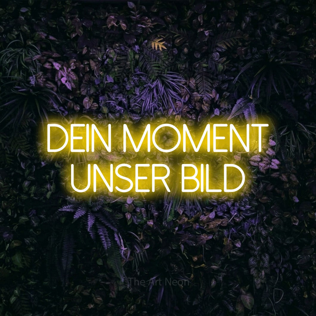 LED neon sign reading “Dein Moment unser Bild”, arranged in 2 lines.