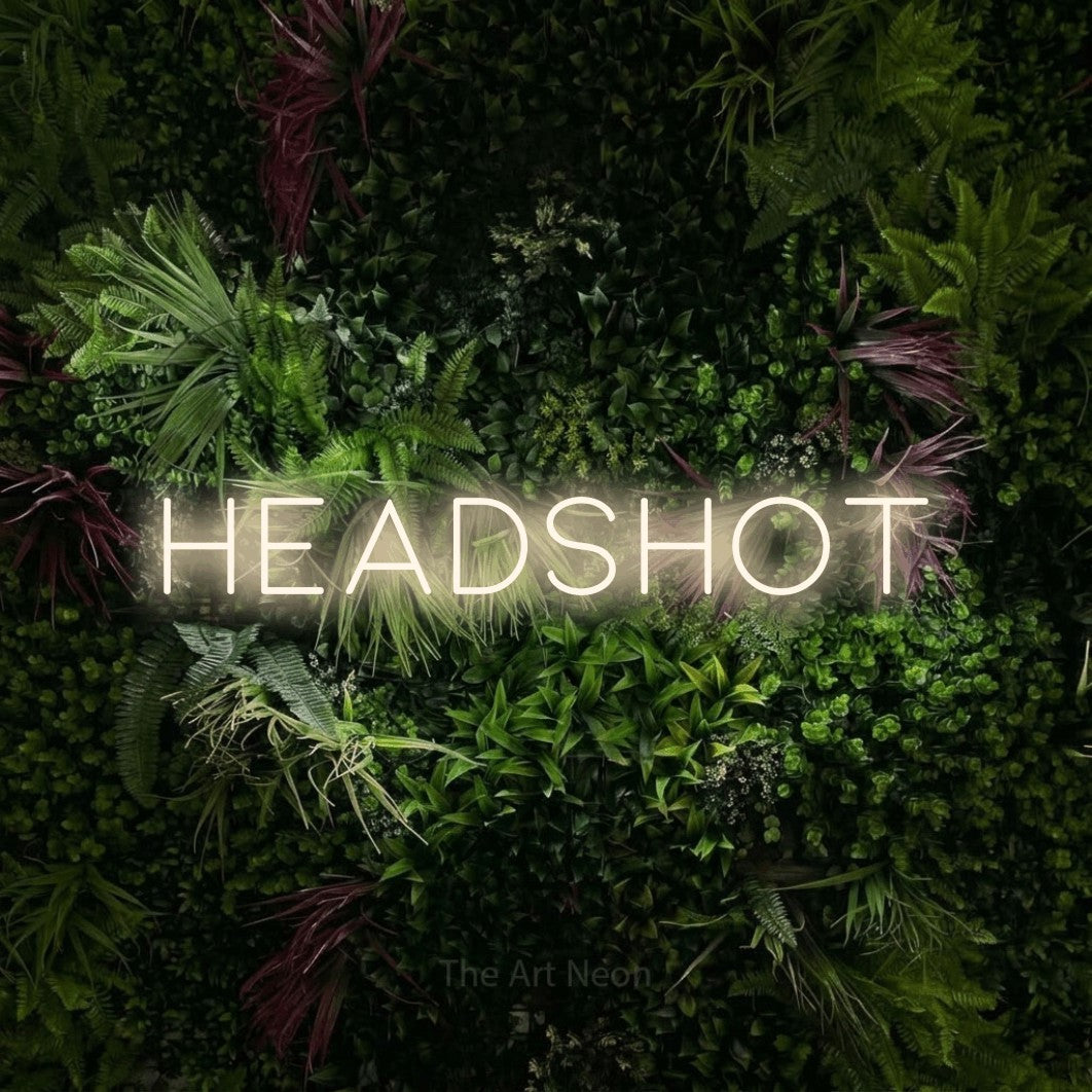 LED neon sign reading “HEADSHOT”, arranged in a single line.