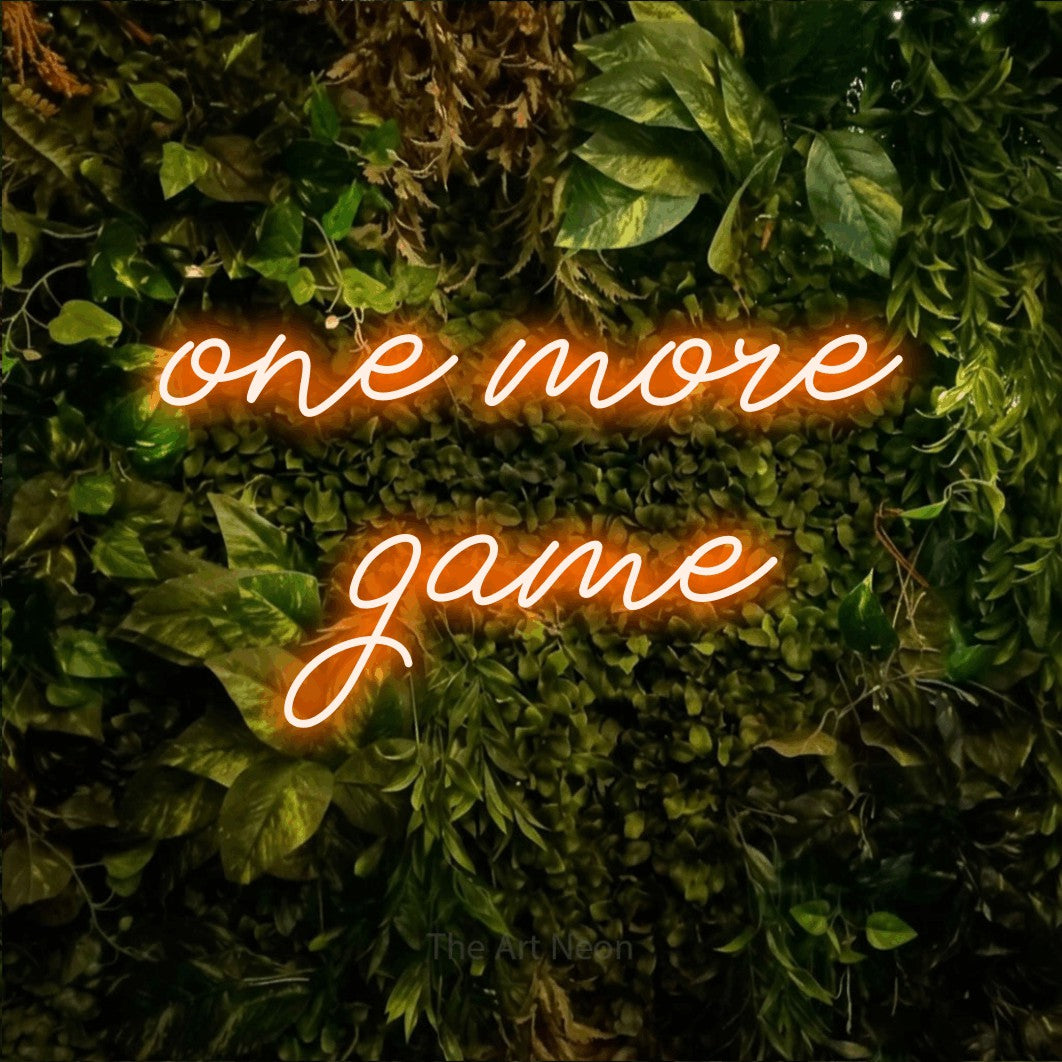 LED neon sign reading “one more game”, arranged in 2 lines.