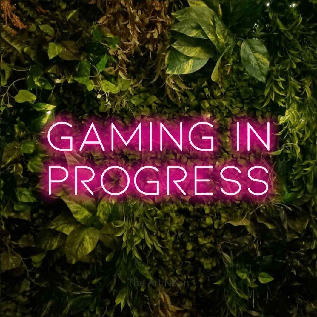 LED neon sign reading “gaming in PROGRESS”, arranged in 2 lines.